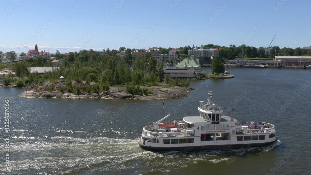Helsinki.Finland-June 16.2021: Amazing shot of a boat traveling between Helsinki and the coastal islands. Tourists. Beautiful sea and nature on a sunny day. Helsinki.Finland-June 16.2021: Amazing shot of a boat traveling between Helsinki and the coastal islands. Tourists. Beautiful sea and nature on a sunny day.