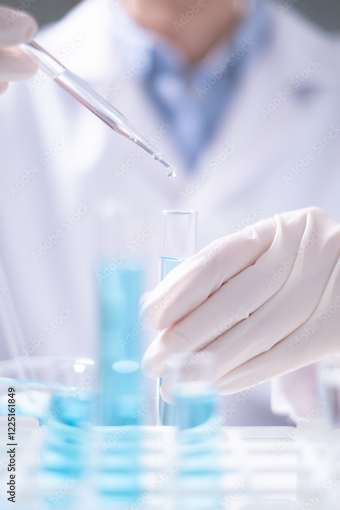 Fototapeta premium Close-up scientist pipette drop to test tube laboratory research chemistry chemical science research