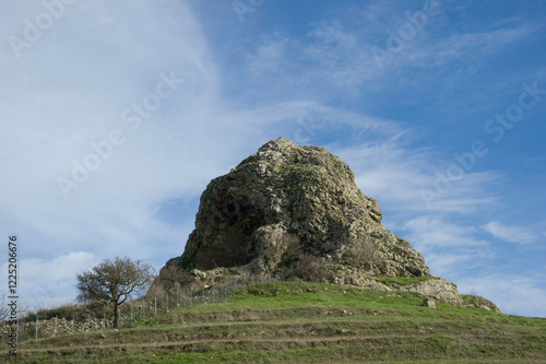 Sa Pedra Mendalza, literally 'the stone that cleans or repairs', is a basalt block about one hundred metres high near the village of Giave, Sardinia photo