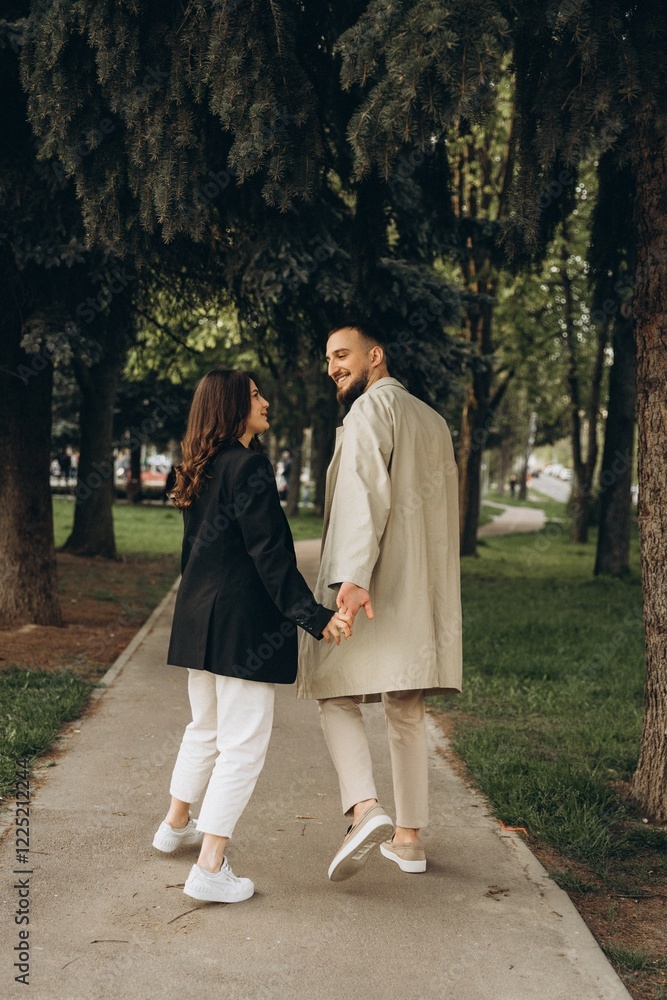 Fototapeta premium a love story of a stylish couple of hipsters dressed in casual clothes who have fun together on a walk , selective focus, noise effect