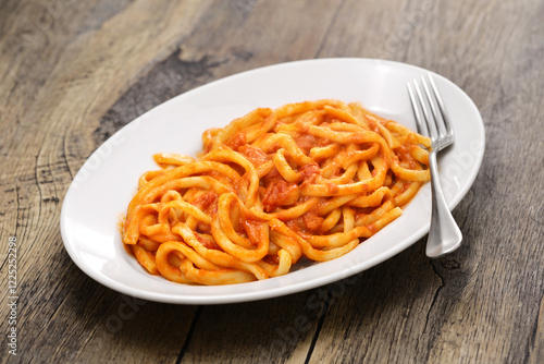Pici all'aglione, a Sienese specialty, thick handmade pasta with garlic tomato sauce.