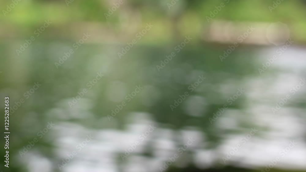blur image from a tranquil scene of a clear blue pool surrounded by lush green foliage. blur image from a tranquil scene of a clear blue pool surrounded by lush green foliage.