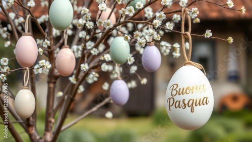 Obraz na płótnie Easter egg tree. Decorated tree with pastel-colored Easter eggs and white blossoms, featuring a large egg with