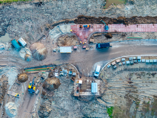 Topdown aerial of heavy machinery doing earth excavation groundworks photo