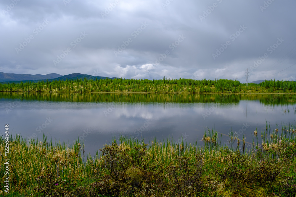 Sunset panorama of small lake with mountain reflection in Siberia, Buryatia, Russia Sunset panorama of small lake with mountain reflection in Siberia, Buryatia, Russia