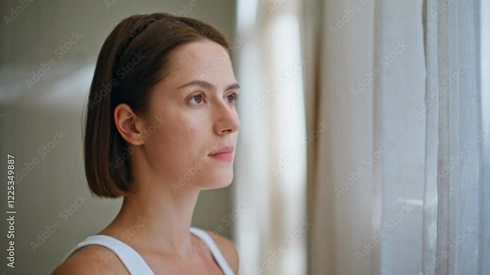 Portrait thoughtful woman gazing out window with calm expression. Natural beauty Portrait thoughtful woman gazing out window with calm expression. Natural beauty