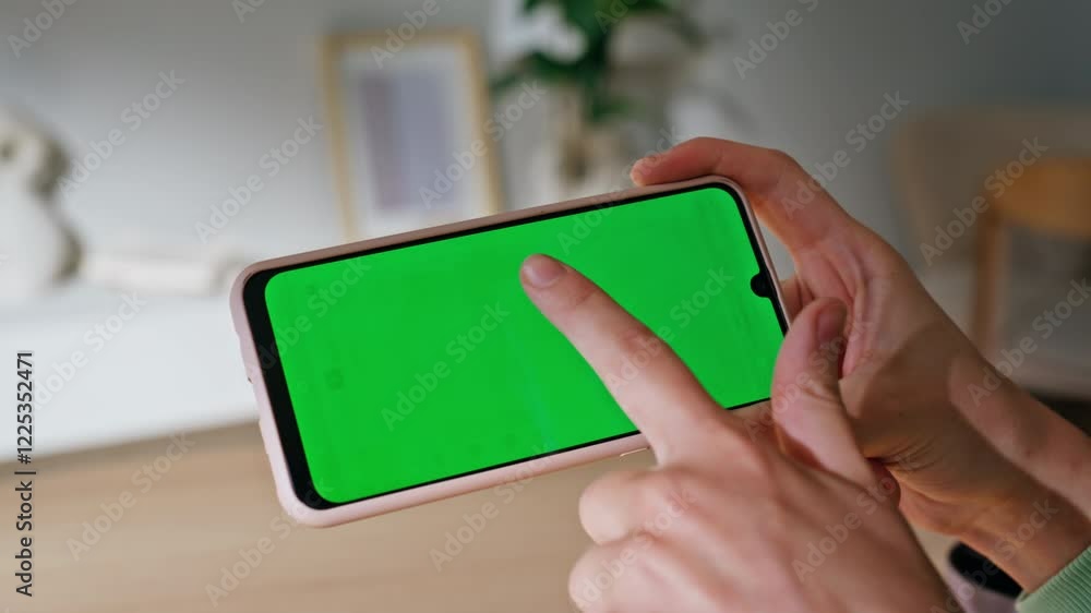 Finger scrolling greenscreen smartphone choosing online purchases home closeup Finger scrolling greenscreen smartphone choosing online purchases home closeup