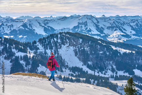 active senior woman  in winter on the Nagelfluh mountain chain near Oberstaufen, Bavaria, Germany photo