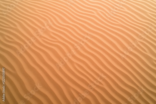 top-down view of fine desert sand with soft rippled texture natural daylight