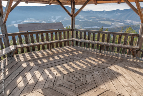 Hexagonal wooden building in the forest.