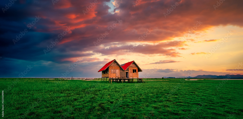 Landscape image of Abandoned twin house near Chalerm Phra Kiat road at sunset in Thale Noi, Phatthalung, Thailand Landscape image of Abandoned twin house near Chalerm Phra Kiat road at sunset in Thale Noi, Phatthalung, Thailand