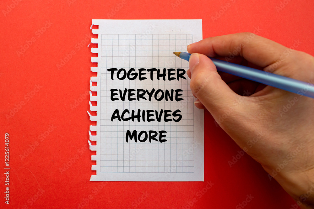Together everyone achieves more message written on white paper on red background. Conceptual together everyone achieves more symbol. Copy space. Together everyone achieves more message written on white paper on red background. Conceptual together everyone achieves more symbol. Copy space.