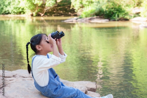 Photography Cute Asian girl using binoculars watch birds