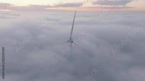 Aerial view of wind turbines under a beautiful sunset with fog and clouds, Duiven, Netherlands. photo