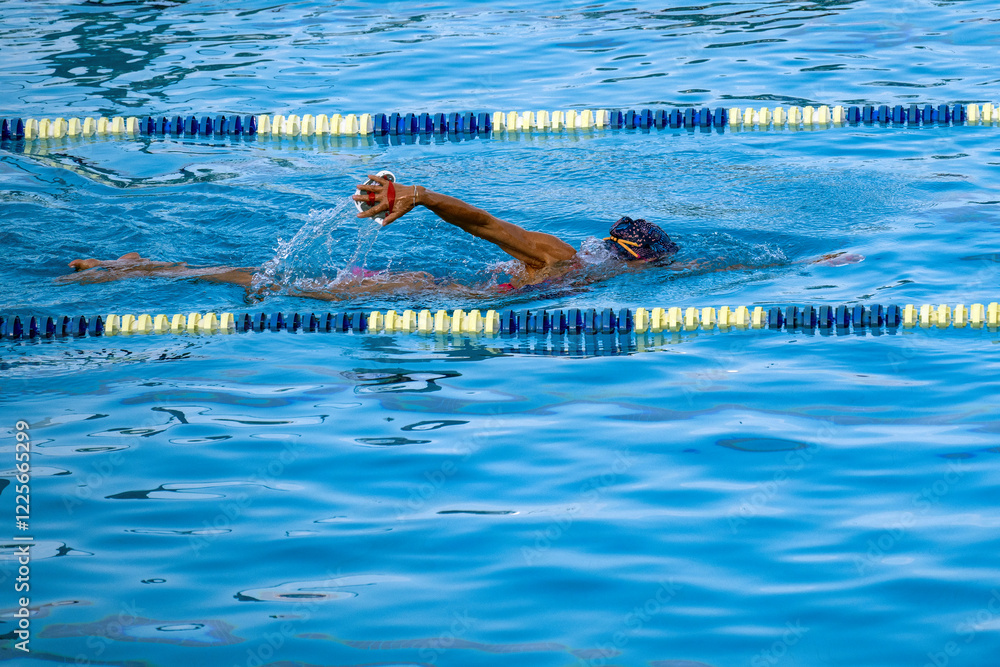 Woman swimming in the central public pool in Monaco Monte Carlo