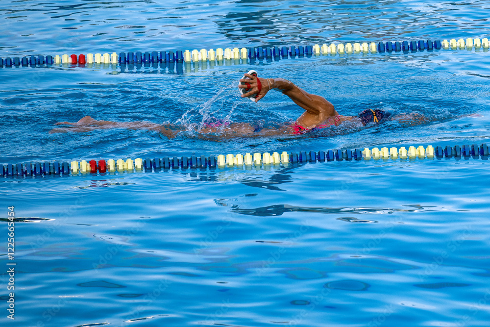 Woman swimming in the central public pool in Monaco Monte Carlo