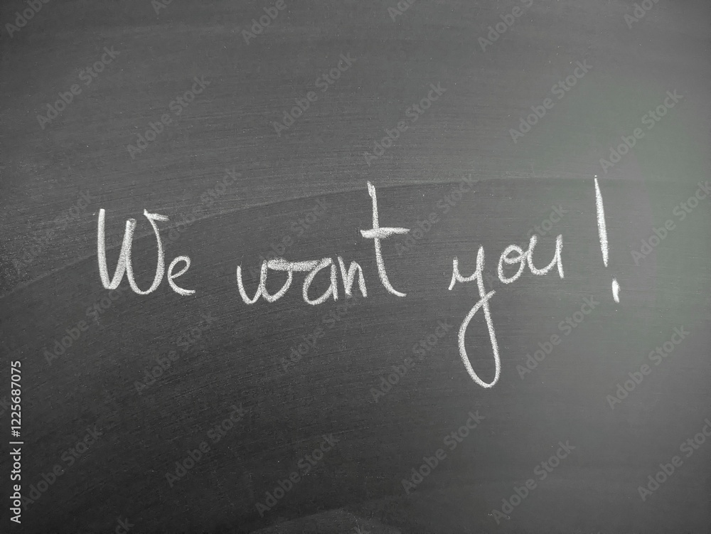Obraz premium Handwritten message on blackboard displaying 'We want you' in white chalk for motivation and recruitment