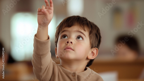 Young Student Raising Hand in Classroom photo