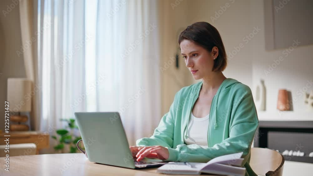 Tired student studying online looking laptop screen at home desk closeup. Tired student studying online looking laptop screen at home desk closeup.