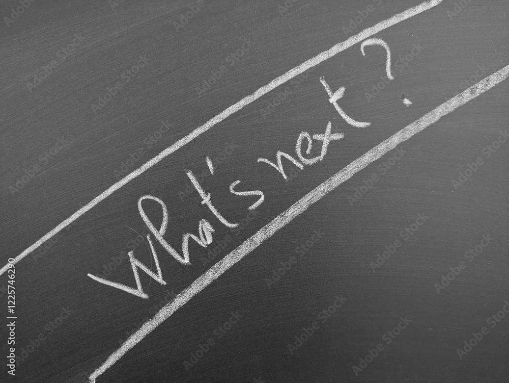 Fototapeta premium Blackboard with handwritten text 'What’s next?' surrounded by underlines, reflecting a thoughtful and introspective theme.