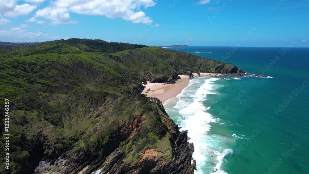 Aerial view of beautiful Whites Beach with cliffs and lush forest, Byron Bay, Australia. Aerial view of beautiful Whites Beach with cliffs and lush forest, Byron Bay, Australia.