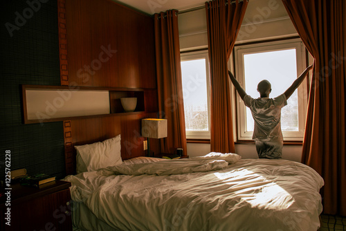 Black woman opening the curtains