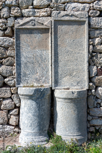 Obraz na płótnie Ancient Greek stone inscriptions in the ruins of Thera, Santorini, Greece, Europe. Historical archaeological site showcasing classical Greek heritage. w salonie