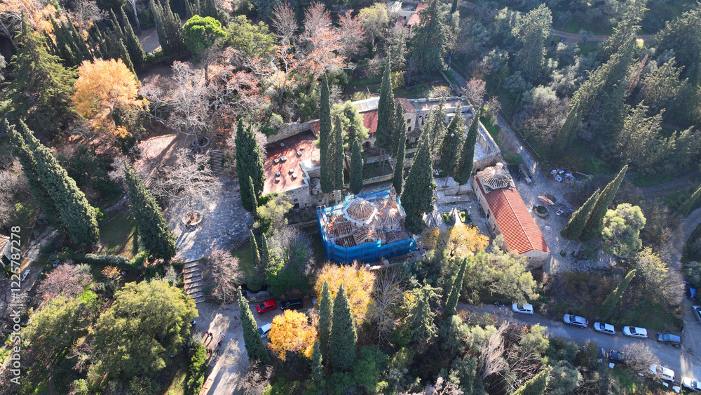 Aerial drone photo of famous Byzantine monastery of Kesariani in the slopes of Hymettus mountain, Attica, Greece