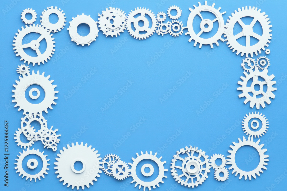 Frame made of different paper gears on blue background
Frame made of different paper gears on blue background