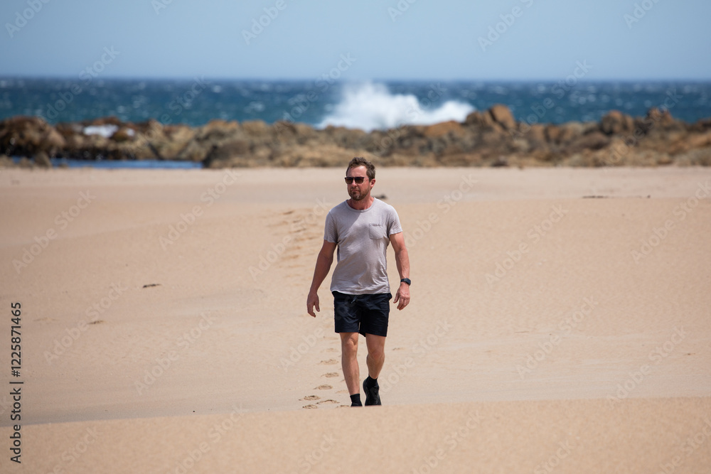 caucasian man walking beach sun blue sky travel caucasian man walking beach sun blue sky travel