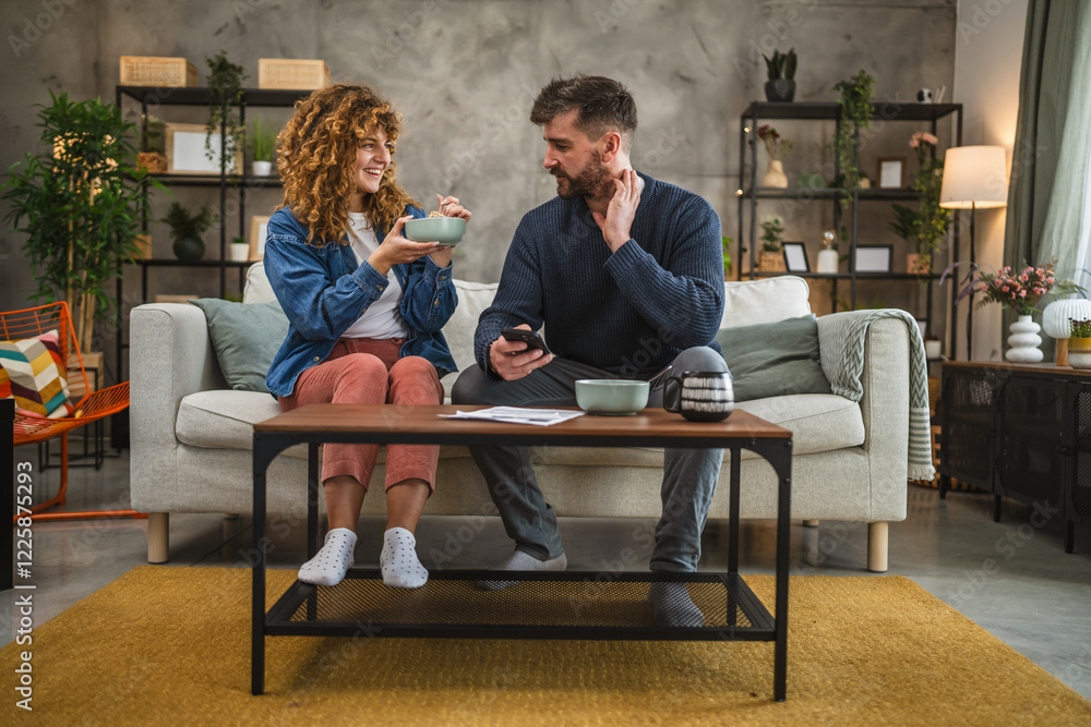 Fototapeta premium couple eat oatmeal and making a contactless payment using smart phone