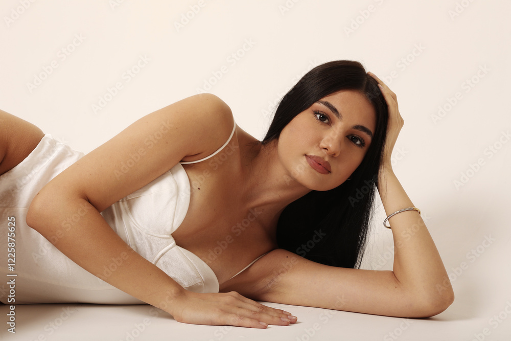 Headshot of beautiful young woman with slim body and long dark hair looking at the camera. Headshot of beautiful young woman with slim body and long dark hair looking at the camera.