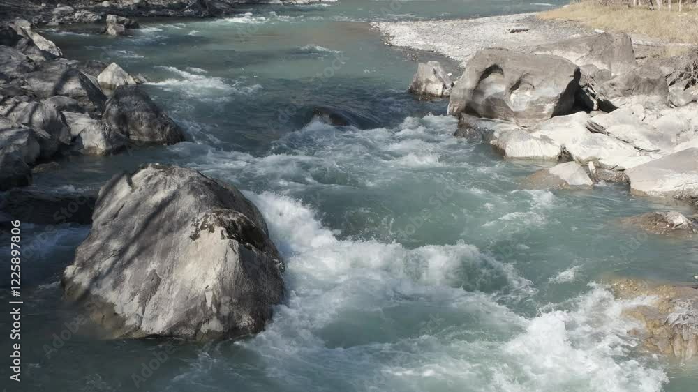 Fast moving stream of seething mountain river runs along stone banks. Altai Fast moving stream of seething mountain river runs along stone banks. Altai
