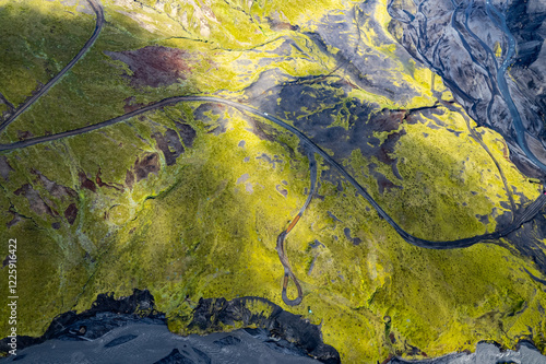 Aerial drone view exploring a river valley landscape with a amazing glacial basin very close to Thakgil (Pakgil) campsite near Vik in Iceland. M.ountains in the background
