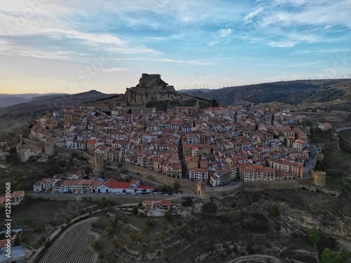 Aerial drone view of the historic medieval walled city and hilltop castle of Morella in Castellon, Valencia, Spain, at sunset