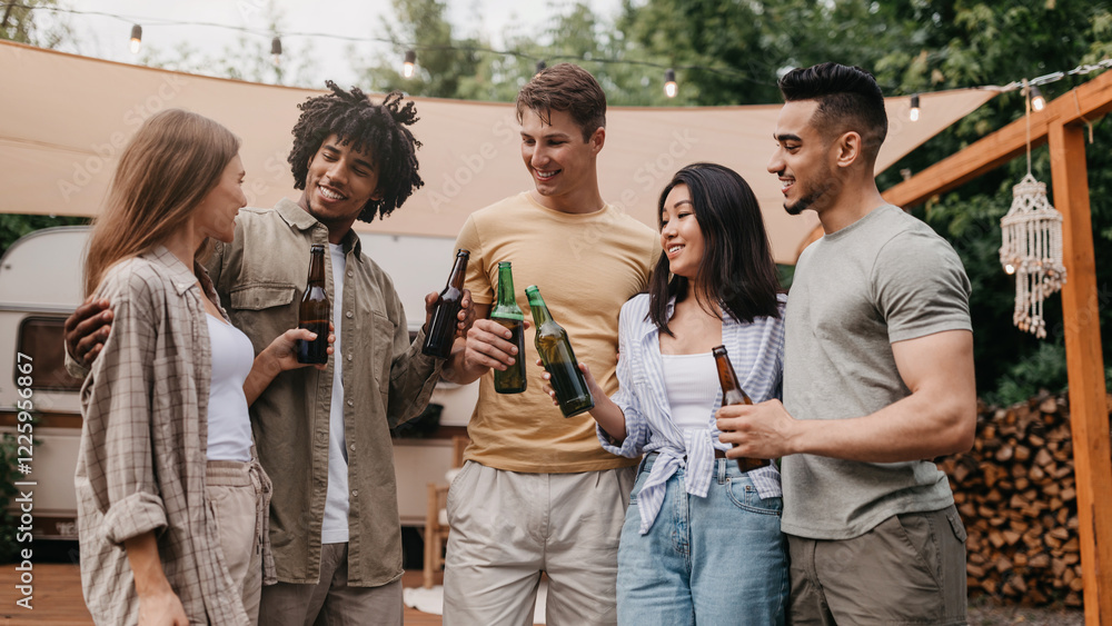 Group of happy multiracial young friends celebrating something, drinking beer, having party near camper van outdoors. Millennial diverse people enjoying summer vacation trip Group of happy multiracial young friends celebrating something, drinking beer, having party near camper van outdoors. Millennial diverse people enjoying summer vacation trip