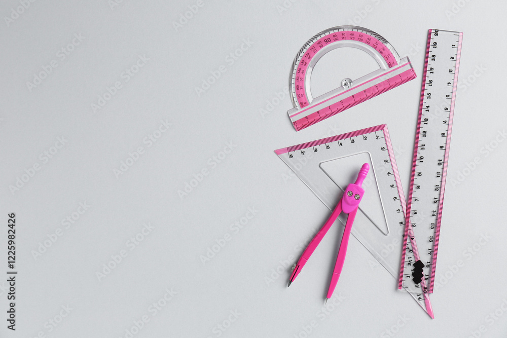 Rulers and compass on light grey background, flat lay. Space for text Rulers and compass on light grey background, flat lay. Space for text