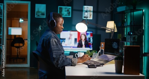 Computer scientist updating artificial intelligence neural networks, writing binary code scripts. Remote worker in apartment office uses digital device programming to upgrade AI, camera B