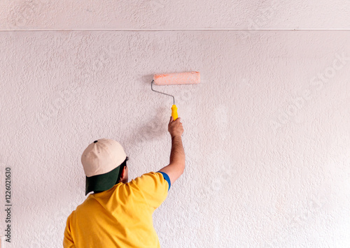 Man painting a wall during home remodeling photo