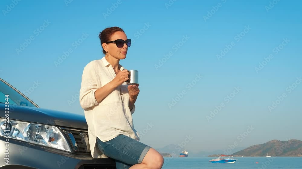 Lady with car resting by summer sea. A view of young lady resting near her car on the camping in the sun light. Lady with car resting by summer sea. A view of young lady resting near her car on the camping in the sun light.