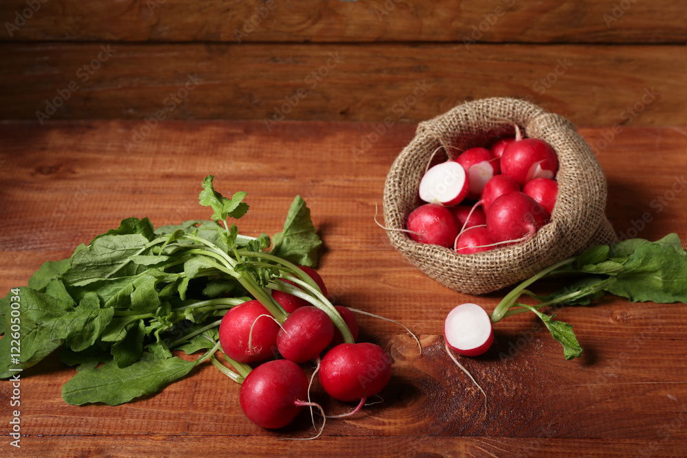 Sack bag of ripe radish and bunch with green leaves on wooden background Sack bag of ripe radish and bunch with green leaves on wooden background