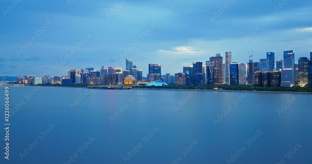 Aerial shot of Hangzhou skyline at dusk with illuminated modern architecture on Qiantang River Aerial shot of Hangzhou skyline at dusk with illuminated modern architecture on Qiantang River