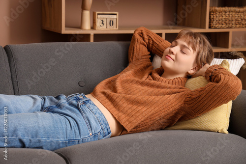 Young woman relaxing on sof...