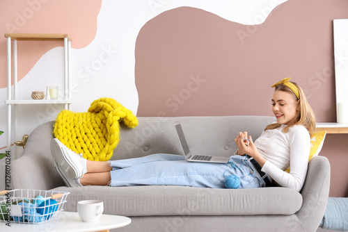 Young woman knitting with n...