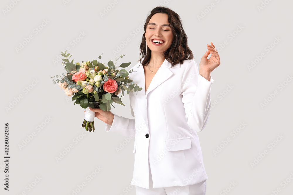 Beautiful bride with wedding bouquet on light background Beautiful bride with wedding bouquet on light background