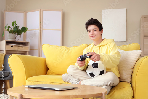 Teenage boy with soccer bal...