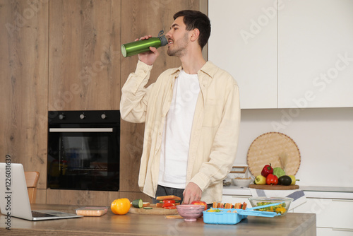 Young man drinking water wh...