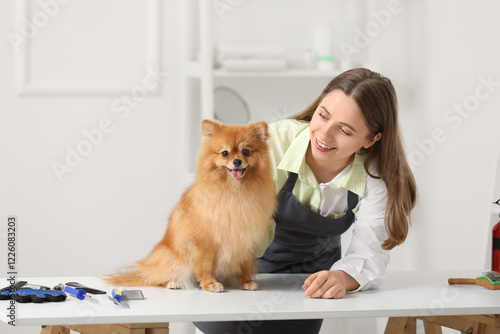 Female groomer with cute Po...