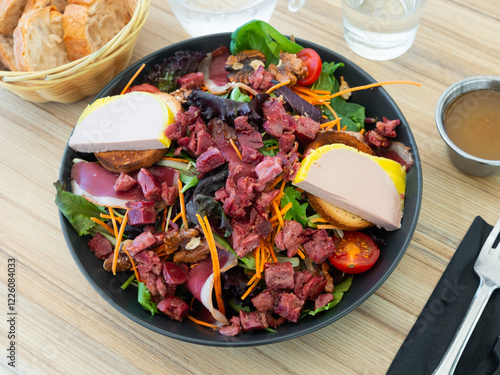 Tableau sur toile Perigord salad - colorful salad with chicken gizzards, tomatoes, cheese and croutons