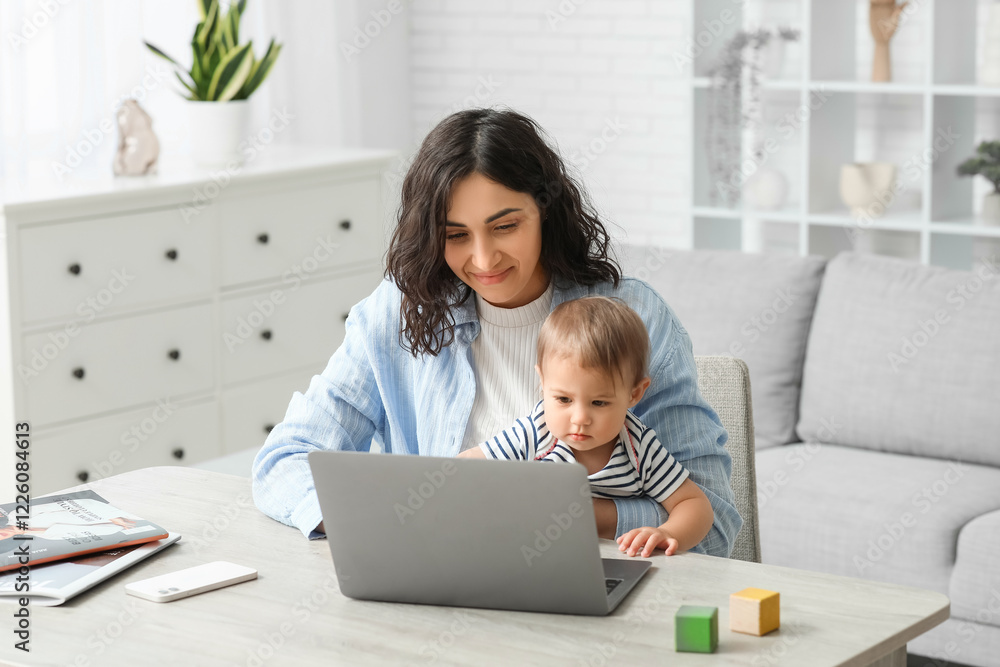 Cute baby and happy young mother working with laptop on maternity leave at home Cute baby and happy young mother working with laptop on maternity leave at home